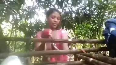 Village girl changing dress ouitdoors after bath