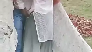 College couple enjoys outdoor sex below a big tree