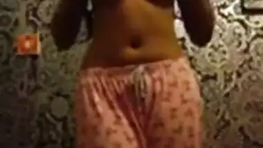 Skinny Indian woman strips in her bedroom. 