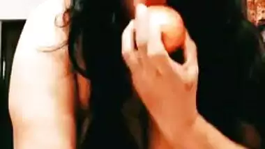 Desi bhabhi with saggy XXX tits inserts an apple into her vagina