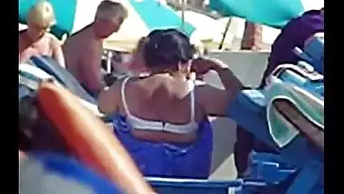 Aunty undresses on foreign beach